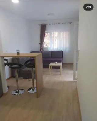 a living room with a couch and a table at Studio in Budva