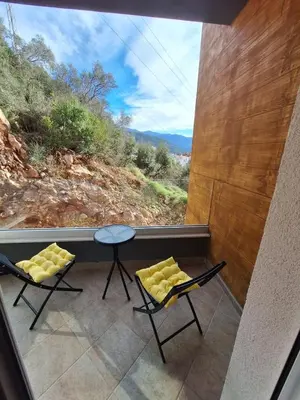 a room with two chairs and a table and a window at Studio in Budva