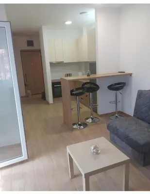 a living room with a couch and a table at Studio in Budva