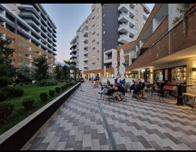 people sitting in chairs on a sidewalk in a building at Studio in Budva