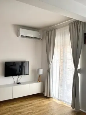 a living room with a tv and a window at Apartment Simovic in Cetinje