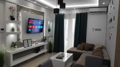 a living room with a couch and a flat screen tv at AJKULICA Apartman in Bar