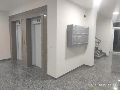 a hallway with white walls and a television on a wall at AJKULICA Apartman in Bar
