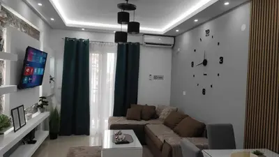 a living room with a couch and a tv at AJKULICA Apartman in Bar