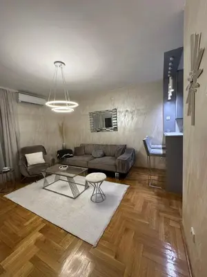 a living room with a couch and a table at IN apartment in Podgorica