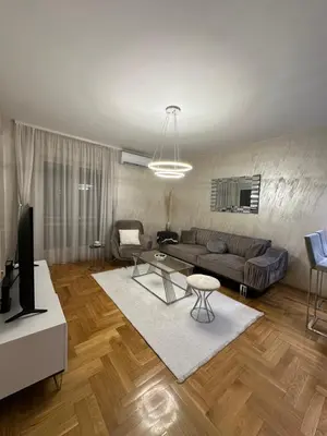 a living room with a couch and a table at IN apartment in Podgorica
