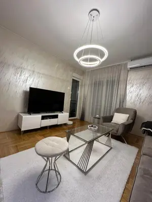 a living room with a television and a table at IN apartment in Podgorica