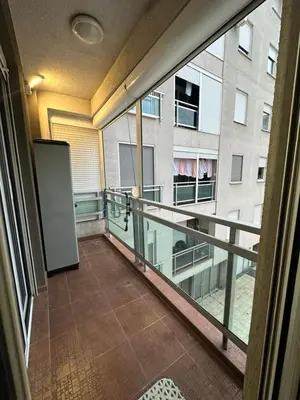 an empty balcony with a view of a building at IN apartment in Podgorica