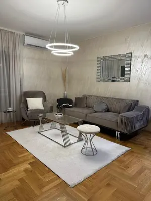 a living room with a couch and a table at IN apartment in Podgorica