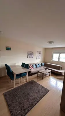 a living room with a couch and a table at City kvart 2 bedroom apartment in Podgorica
