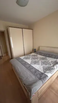 a bedroom with a large bed with at City kvart 2 bedroom apartment in Podgorica