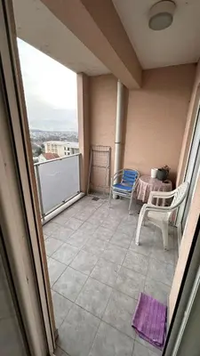 a view of a balcony with two chairs and a table at City kvart 2 bedroom apartment in Podgorica
