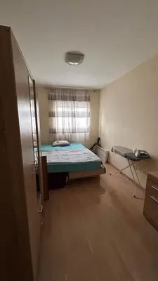 a small bedroom with a bed and a window at City kvart 2 bedroom apartment in Podgorica