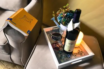 a bottle of wine and a glass on a table at Apartment Godfather in Budva