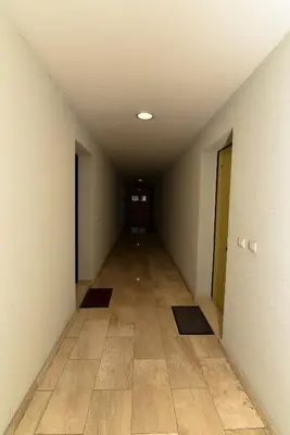 an empty hallway with a tile floor at Apartment Godfather in Budva