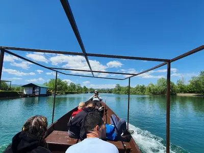 a group of people on a boat on the water at Luxurious attic apartment with a breathtaking view in Vranjina