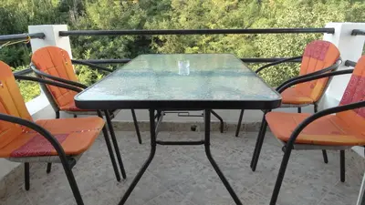 a table and chairs on a balcony with a view at Studios Zoran Milosev in Bar
