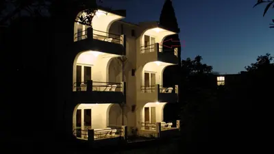 a white building with lights on the side of it at Studios Zoran Milosev in Bar