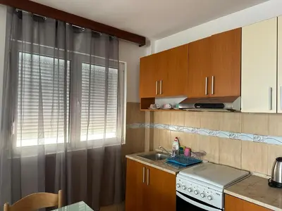 a kitchen with a sink and a window at Apartmani Jovan in Budva