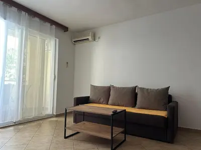 a living room with a couch and a table at Apartmani Jovan in Budva