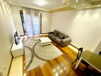 a living room with a couch and a table at City center apartment in Podgorica