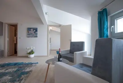 a living room with a couch and a table at Apartments Kuljace in Sveti Stefan