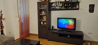 a living room with a flat screen tv on a entertainment center at City kvart apartment in Podgorica