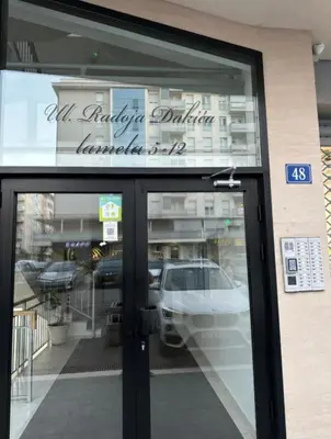 a store front door with a car in the window at City kvart apartment in Podgorica