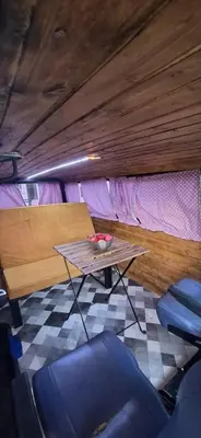 a table with a bowl of fruit on it in a room at Camper t4 in Danilovgrad