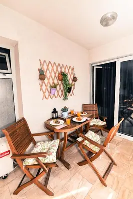 a dining room with a table and chairs at Marilyn Apartment in Budva