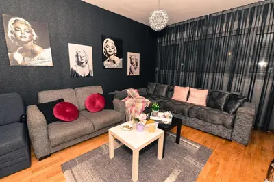 a living room with a couch and a table at Marilyn Apartment in Budva