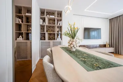 a dining room with a table with a vase on it at Villa Del Sol in Budva