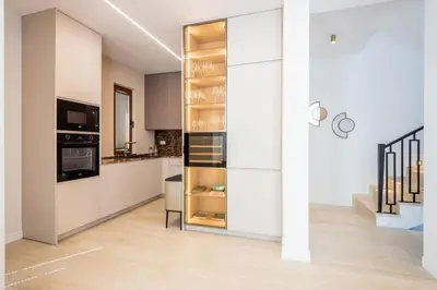 a kitchen with white cabinets and a refrigerator at Villa Del Sol in Budva