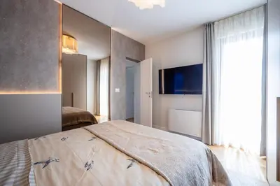 a bedroom with a bed and a large window at Villa Del Sol in Budva