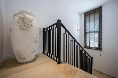 a large white vase sitting next to a staircase at Villa Del Sol in Budva