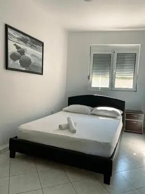 a bedroom with a bed with a phone on it at Villa Perla in Utjeha