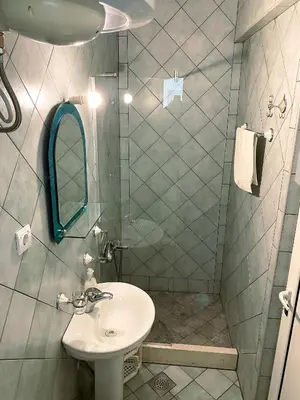 a bathroom with a sink and a shower with a mirror at Villa Perla in Utjeha
