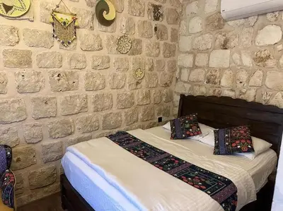 a bedroom with a stone wall with a bed at levent 2 in Kotor