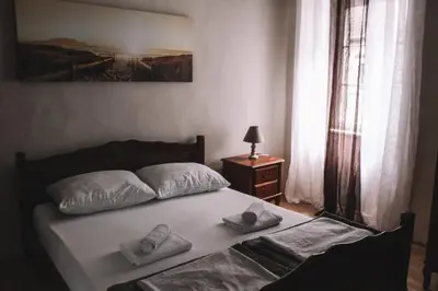 a bedroom with a bed with two pillows on it at levent 2 in Kotor