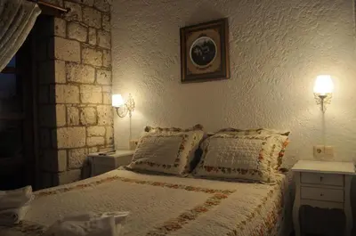 a bedroom with a bed with two lamps on the wall at levent 2 in Kotor