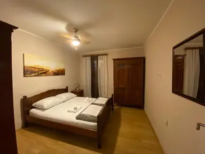 a bedroom with a bed and a table with cups on it at levent 2 in Kotor