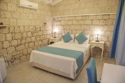 a bedroom with a large bed with blue pillows at levent 2 in Kotor