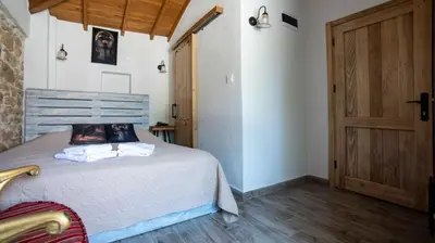 a bedroom with a bed and a wooden door at levent 2 in Kotor