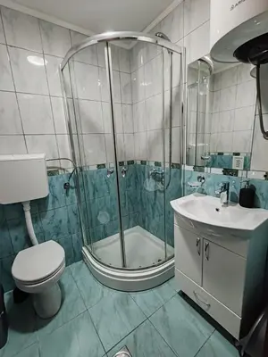 a bathroom with a shower and a toilet and a sink at Villa Contact in Dobra Voda