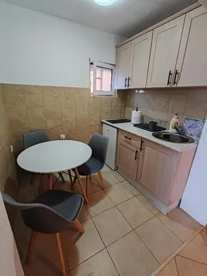 a kitchen with a table and chairs and a sink at Villa Contact in Dobra Voda
