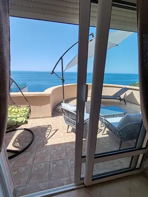 a sliding glass door with a view of the ocean at Villa Contact in Dobra Voda