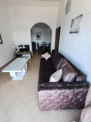 a living room with a couch and a table at Villa Contact in Dobra Voda