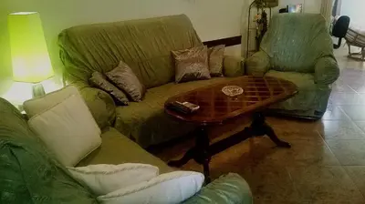 a living room with a couch and a coffee table at Family House Pavicevic in Bar