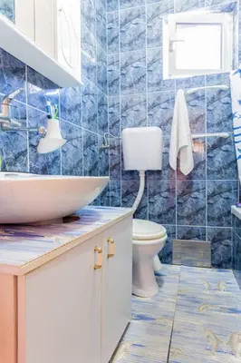 a bathroom with a sink and a toilet at Family House Pavicevic in Bar