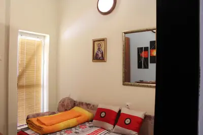 a living room with a couch and a mirror at Family House Pavicevic in Bar